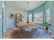 Bright dining room with wood floors, large windows, and table set for six, creating an inviting atmosphere at 1639 Wakefield Dr, Brandon, FL 33511