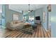 Cozy living room with wood floors, area rug, ceiling fan, and sliding door to outdoor space at 1639 Wakefield Dr, Brandon, FL 33511