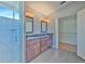 Bright main bathroom featuring double vanity sinks, tile floors, and walk-in shower with glass door at 1639 Wakefield Dr, Brandon, FL 33511