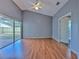 Airy main bedroom with a sliding door access to backyard and vaulted ceiling with ceiling fan at 1639 Wakefield Dr, Brandon, FL 33511