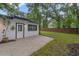A backyard with a brick patio, fencing and green grass surround the property at 1715 N Alexander Rd, Tampa, FL 33603