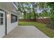 The house features a brick patio and a fully fenced backyard with trees at 1715 N Alexander Rd, Tampa, FL 33603
