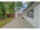 A backyard featuring brick paving and a detached garage with double doors at 1715 N Alexander Rd, Tampa, FL 33603