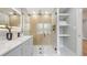 Contemporary bathroom boasts a glass shower, open shelving, and a sleek vanity with modern fixtures at 1715 N Alexander Rd, Tampa, FL 33603