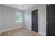 Light-filled bedroom with wood floors, modern trim, window, and stylish dark doors at 1715 N Alexander Rd, Tampa, FL 33603