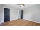 Spacious bedroom with wood floors, neutral walls, and contrasting doors leading to other rooms at 1715 N Alexander Rd, Tampa, FL 33603