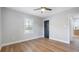 Bedroom featuring wood-look floors, neutral paint, a ceiling fan, and contrasting trim and doors at 1715 N Alexander Rd, Tampa, FL 33603