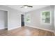 Bedroom features wood-look floors, neutral walls, contrasting trim and doors, and lots of natural light at 1715 N Alexander Rd, Tampa, FL 33603