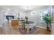 Contemporary dining room with sleek furnishings, modern lighting, and an open layout to the kitchen at 1715 N Alexander Rd, Tampa, FL 33603
