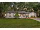 Charming single story home with a well-manicured lawn and tidy landscaping at 1715 N Alexander Rd, Tampa, FL 33603