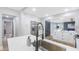 Open-concept kitchen featuring stainless steel appliances, white cabinetry, and a view to living space at 1715 N Alexander Rd, Tampa, FL 33603