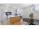 Bright, open kitchen with a view to the dining room, modern appliances, and white cabinetry at 1715 N Alexander Rd, Tampa, FL 33603