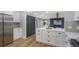 Stylish kitchen featuring white cabinetry, stainless steel appliances, and a view to the living room at 1715 N Alexander Rd, Tampa, FL 33603