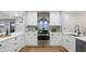 Modern kitchen featuring white cabinetry, stainless steel appliances, and clean countertops at 1715 N Alexander Rd, Tampa, FL 33603