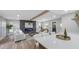 Bright living room featuring an electric fireplace, beam, and light hardwood flooring at 1715 N Alexander Rd, Tampa, FL 33603