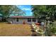 Exterior of home with lawn and a variety of container plants in the backyard at 1755 Sunset Point Rd, Clearwater, FL 33755