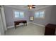 Empty bedroom with a vintage desk and dual windows with shutter coverings at 1755 Sunset Point Rd, Clearwater, FL 33755