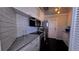 Modern kitchen featuring stainless appliances, white cabinetry, and tiled backsplash at 1755 Sunset Point Rd, Clearwater, FL 33755