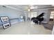 Spacious living room boasts a beautiful terrazzo floor, coffered ceilings, and grand piano at 1755 Sunset Point Rd, Clearwater, FL 33755