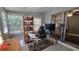 Cozy office space offering a glass top desk, modern decor, and views of the exterior at 1755 Sunset Point Rd, Clearwater, FL 33755