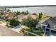 Aerial shot showcasing a home with a spacious lot, mature landscaping, and stunning lake views in a desirable neighborhood at 1858 Mira Lago Cir, Ruskin, FL 33570