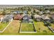 Large grassy backyard perfect for activities, with a screened pool and a calming lake backdrop at 1858 Mira Lago Cir, Ruskin, FL 33570