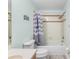 Bright bathroom featuring a tub with shower, decorative curtain, and blue accents at 1858 Mira Lago Cir, Ruskin, FL 33570