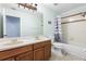 Well-lit bathroom featuring a double sink vanity and shower-tub combo, maximizing functionality at 1858 Mira Lago Cir, Ruskin, FL 33570
