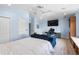 Bright and airy bedroom featuring a bed, blue couch, and office nook at 1858 Mira Lago Cir, Ruskin, FL 33570
