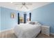 Serene bedroom featuring blue walls, dual windows, and a comfortable queen-sized bed at 1858 Mira Lago Cir, Ruskin, FL 33570