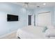 Bright bedroom with blue walls features a mounted tv, closet, and comfortable bed at 1858 Mira Lago Cir, Ruskin, FL 33570