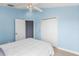Bright bedroom offers a ceiling fan, closet, and comfortable bed at 1858 Mira Lago Cir, Ruskin, FL 33570