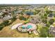 Aerial view of the community pool area, featuring a pool, clubhouse, and sports courts at 1858 Mira Lago Cir, Ruskin, FL 33570