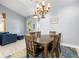 Charming dining room featuring a wooden table, chandelier, and bright natural lighting at 1858 Mira Lago Cir, Ruskin, FL 33570