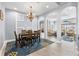 Elegant dining area connected to a bright, open-concept living space with archways and tile floors at 1858 Mira Lago Cir, Ruskin, FL 33570
