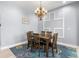 Formal dining room featuring modern decor, stylish lighting, and comfortable seating for six at 1858 Mira Lago Cir, Ruskin, FL 33570