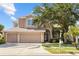Charming two-story home with a three-car garage, well-maintained lawn, and mature landscaping at 1858 Mira Lago Cir, Ruskin, FL 33570