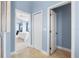 Hallway with tile flooring and doorways to the bedroom and other rooms, showcasing the home's layout at 1858 Mira Lago Cir, Ruskin, FL 33570