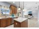 Stylish kitchen featuring granite countertops, stainless steel appliances, and a living room view at 1858 Mira Lago Cir, Ruskin, FL 33570