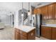 Modern kitchen features granite countertops, stainless steel appliances, and a view into the living room at 1858 Mira Lago Cir, Ruskin, FL 33570