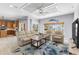 Open living room with ceiling fan, tan sofa and chairs, and a view of the swimming pool at 1858 Mira Lago Cir, Ruskin, FL 33570