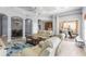 Spacious living area featuring neutral tones, a sliding glass door, and a glimpse of the kitchen at 1858 Mira Lago Cir, Ruskin, FL 33570