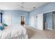 Tranquil main bedroom featuring blue walls, white doors, and access to the en suite bathroom at 1858 Mira Lago Cir, Ruskin, FL 33570