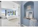 Bedroom featuring blue walls, a white bed, and a view of the outside greenery at 1858 Mira Lago Cir, Ruskin, FL 33570