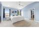 Spacious main bedroom with water views, blue walls, white carpet, and ample natural light at 1858 Mira Lago Cir, Ruskin, FL 33570