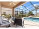 Relaxing screened patio with a cozy seating area and views of the sparkling pool at 1858 Mira Lago Cir, Ruskin, FL 33570