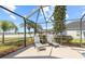 Covered patio with stylish lounge chairs and views of the yard, perfect for relaxing at 1858 Mira Lago Cir, Ruskin, FL 33570