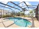 Screened-in pool area with a kidney-shaped pool and lounge chairs, perfect for relaxation and enjoying sunny days at 1858 Mira Lago Cir, Ruskin, FL 33570