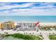Aerial view showcasing the building's location near the beach and parking lot at 18650 Gulf Blvd # 203, Indian Shores, FL 33785