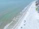 Gorgeous aerial view of the pristine beach with soft waves meeting the shoreline at 18650 Gulf Blvd # 203, Indian Shores, FL 33785